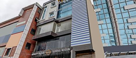 A building with a Charcoal Museum sign, modern architecture, and a ground floor to-let sign.