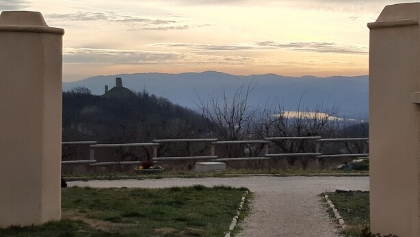 A pathway leading to a scenic overlook with mountains in the background.
