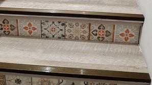 A staircase with multiple steps, each adorned with a variety of patterned tiles.
