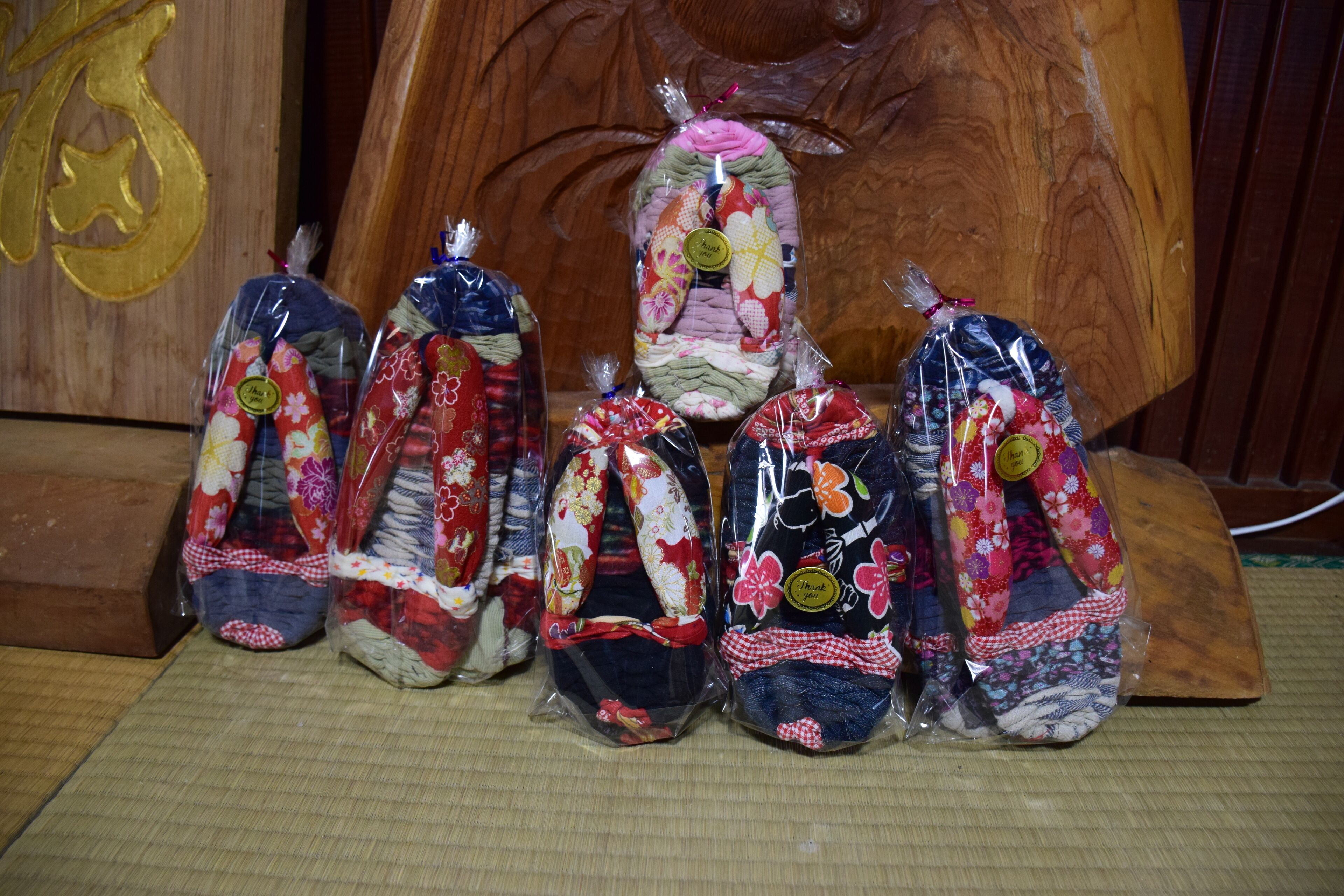 A collection of fabric items displayed on a wooden surface.