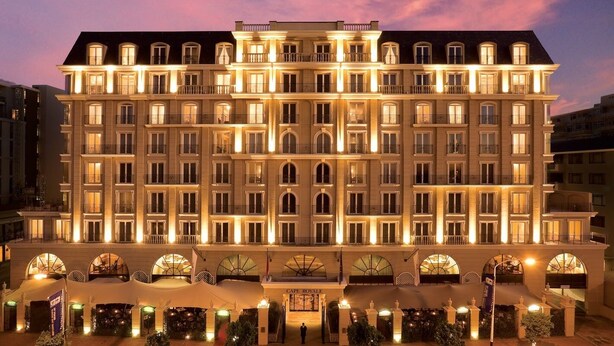 A large, multi-story hotel with a symmetrical facade, multiple balconies, and a grand entrance with a covered area. - Unit Number 620 Cape Royale Luxury Apartments (Cape Town)