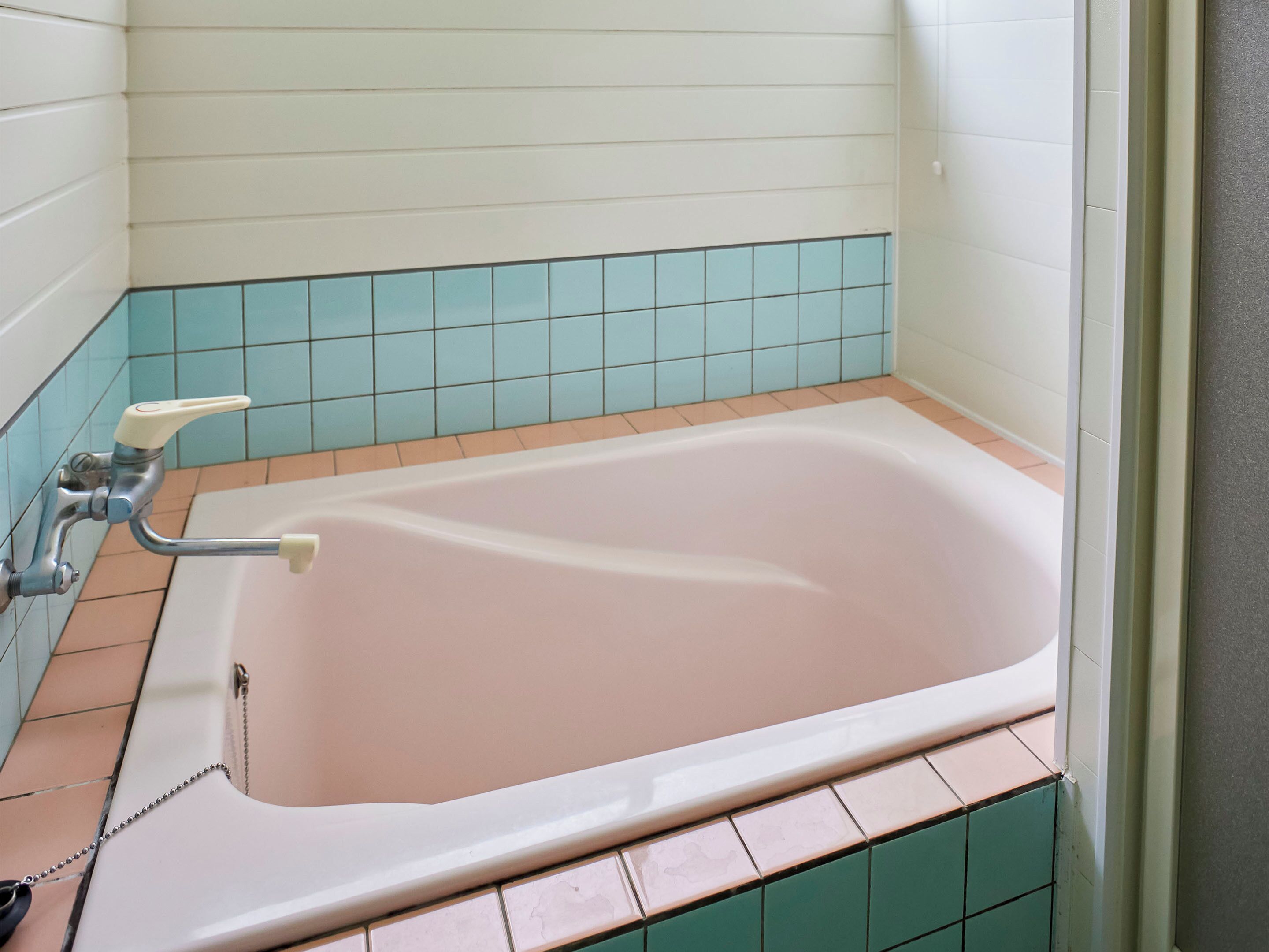 A bathroom with a bathtub, a shower, and a toilet.