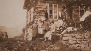 A rustic log cabin with a stone foundation, a wooden porch, and a chimney. - Westerås Gard (Stranda)