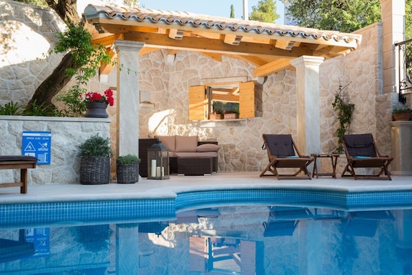 A heated pool, pool loungers