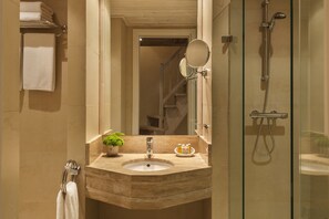 A bathroom with a marble sink, a glass-enclosed shower, and a mirror above the sink. - Santa Marina Arachova Resort & Spa (Distomo-Arachova-Antikyra)