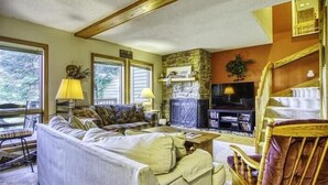 A cozy living room with a sofa, armchairs, a fireplace, and a television. - DF109- Centrally located in Canaan Valley! Pool! (Davis)