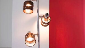 A modern light fixture with two exposed bulbs mounted on a vertical pole. - Not Ninja Kyocera Dome 1 - 5th Floor Room (Osaka)
