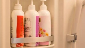 A bathroom shelf with three bottles of toiletries. - Not Ninja Kyocera Dome 1 - 5th Floor Room (Osaka)