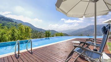 Seasonal outdoor pool, open 8:00 AM to 7:00 PM, pool umbrellas