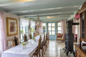 A dining room with a long table set for six, surrounded by wooden chairs. - Villa Solvorn (Luster)