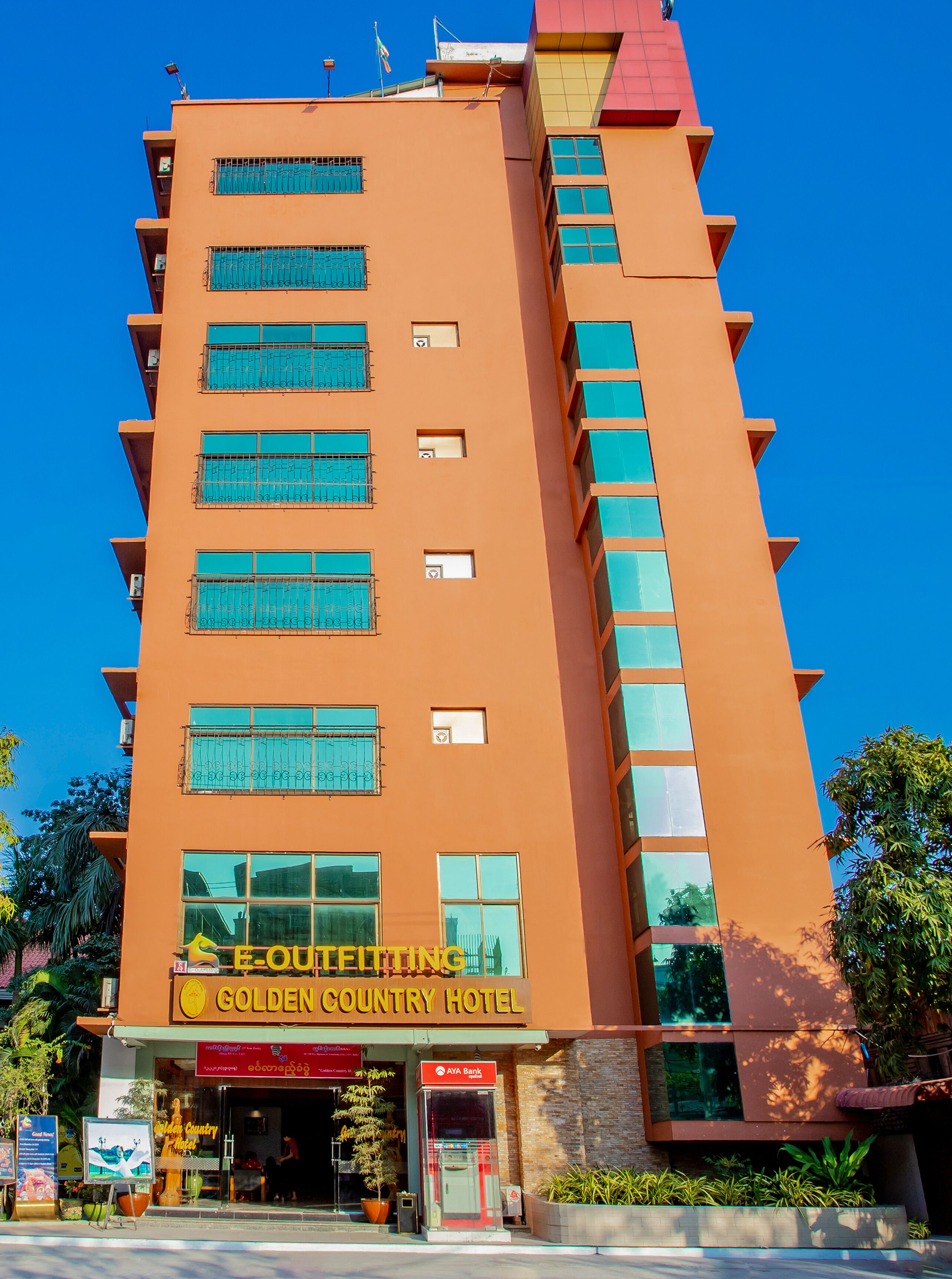 A multi-story hotel with a prominent sign for the Golden Country Hotel.