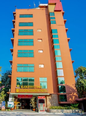 A multi-story hotel with a prominent sign for the Golden Country Hotel. - E-Outfitting Golden Country Hotel (Mandalay)