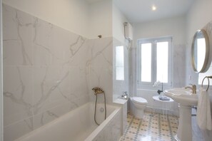 Bathtub, hair dryer, towels, soap