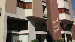 A multi-story hotel with a prominent brown vertical sign reading "Crystal Apart Hotel". - Crystal Apart Hotel (Macaé)