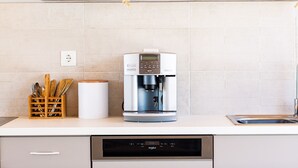 A kitchen with a coffee maker, a dish rack, and a dish soap dispenser. - Evilio Suites, Inspired Family Retreat with Pool (Prinos, Rethymno)