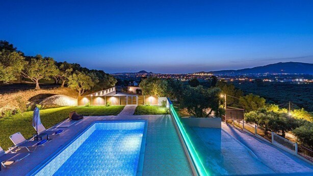 A swimming pool with a view of a cityscape at dusk. - 2 Bedroom Villa, Sarakina, Zakynthos (Sarakina)