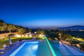 A swimming pool with a view of a cityscape at dusk. - 2 Bedroom Villa, Sarakina, Zakynthos (Sarakina)