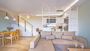 A modern living room with a sectional sofa, wooden dining table, and chairs. - 2 Bedroom Villa, Sarakina, Zakynthos (Sarakina)