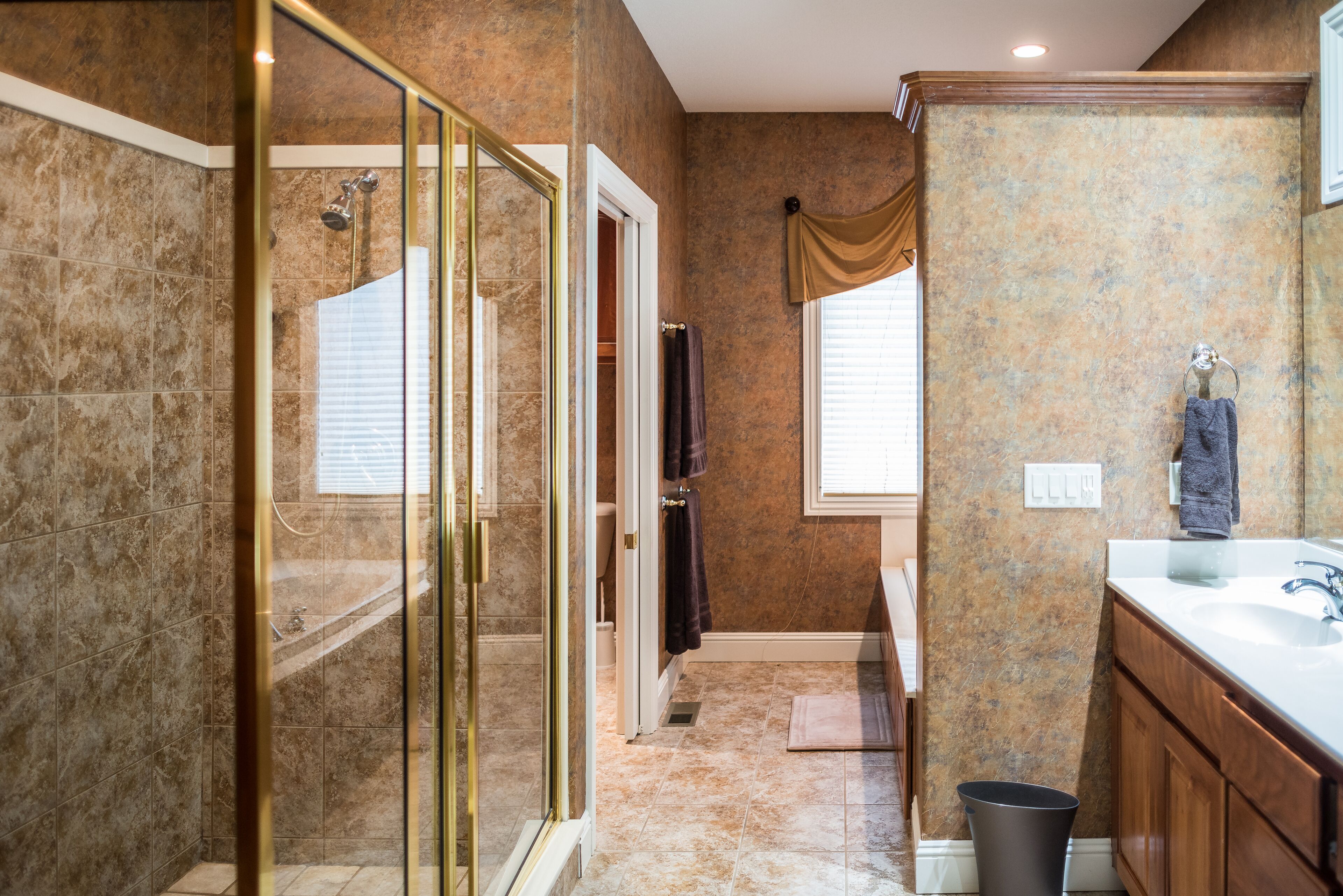 A bathroom with a shower, toilet, and sink.