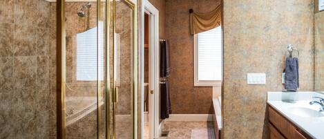 A bathroom with a shower, toilet, and sink.