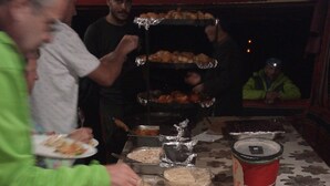 A buffet table with various food items and a person serving food. - Ultimate (Wadi Rum)