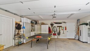 A garage with a ping pong table, shelves with bags, and various tools. - Walk to Ski Lodge..Mountain Views..Includes Ski Lodge Locker (Sugar Mountain)