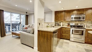 A modern kitchen with wooden cabinets, a built-in microwave, and a stainless steel oven. - Heavenly 2BR/2BA. Private Hot-tub & Mountain View’s (Whistler)