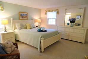 A bedroom with a bed, nightstands, a dresser, a mirror, and a window. - Walk to Beach Central AC WiFi Beach Pearl (Chatham)
