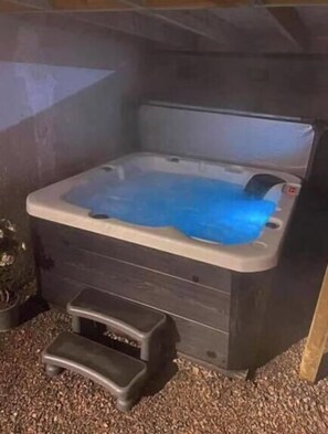 A hot tub with a step stool in front.