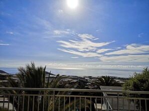 A balcony with a view of the sea and clouds.