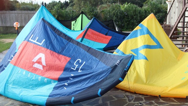 Three large tents with different colors and designs, set on a stone patio. - IL GABBIANO (IUN: P5444) (San Giovanni Suergiu)