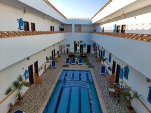 Indoor pool, open 8:00 AM to 11:00 AM, pool loungers