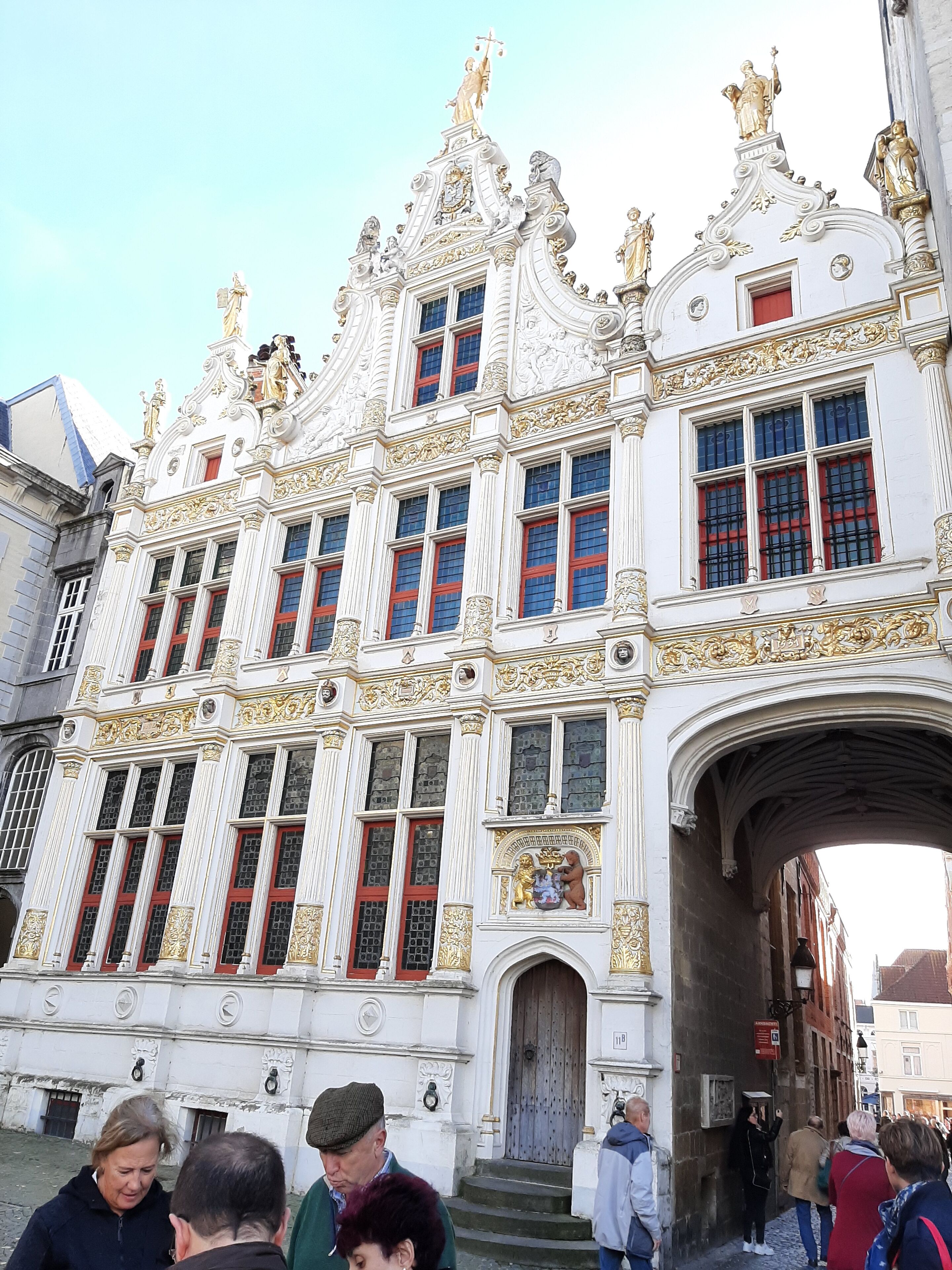 A historic building with ornate architecture, including statues and detailed carvings.