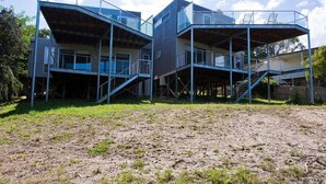 A modern multi-level building with outdoor staircases and balconies.