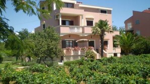 A multi-story building with balconies, surrounded by a vineyard. - Apartment in Zaton (Zadar) with Seaview, Loggia, Air condition, WIFI (4810-4) (Zaton)