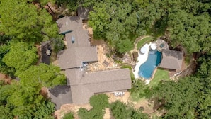 An aerial view of a house with a large backyard, a swimming pool, and a separate building. - Sleeps 15 | Private custom pool | Hot Tub on 7 Secluded Acres (Holly Lake Ranch)