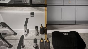A modern bathroom with a large mirror, dual sinks, and a variety of toiletries.