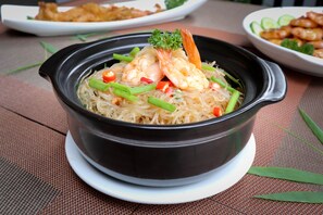 A bowl of noodles with shrimp and vegetables on a table. - Dream Countryside Villa (Siem Reap)