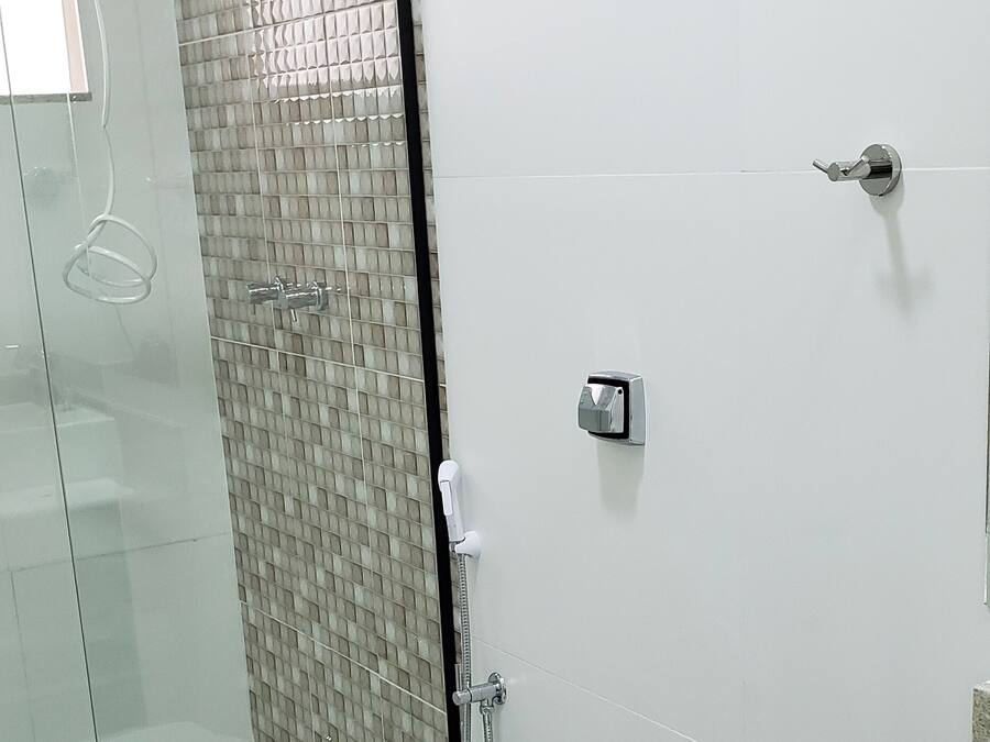 A modern bathroom with a glass-enclosed shower, a toilet, and a bathtub.