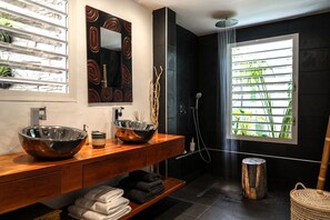 Bathtub, hair dryer, towels, toilet paper
