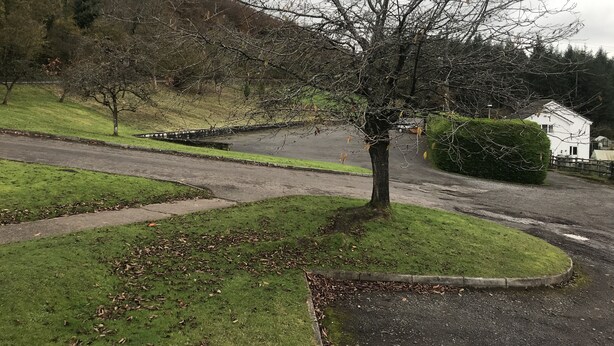 A residential area with a tree-lined street, a white house, and a paved road. - The Huntsman Hotel (Chepstow)