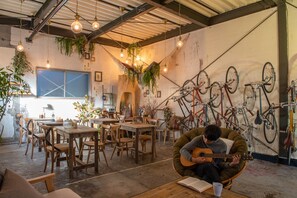 Relax in a cozy café with rustic charm, comfortable seating, and a lively atmosphere.