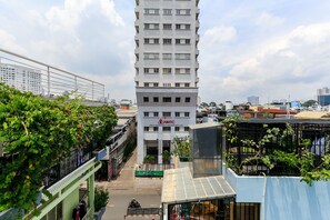 A multi-story building with a sign reading "HMTC" and a green awning. - 1991 Home Sai Gon (Ho Chi Minh City)