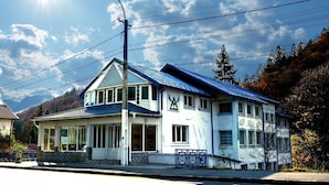 A two-story building with a blue roof and a sign that reads "ALIMAR". - Alimar (Predeal)