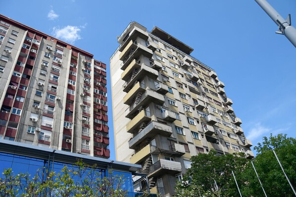 A high-rise building with multiple balconies and a modern architectural design.