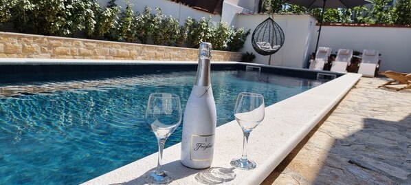 Outdoor pool, pool umbrellas, sun loungers