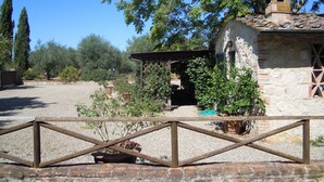 A rustic stone building with a wooden roof and a small bell tower. - single house in tuscany (SIENA)