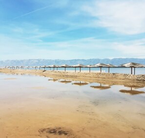 On the beach, sun-loungers, beach towels