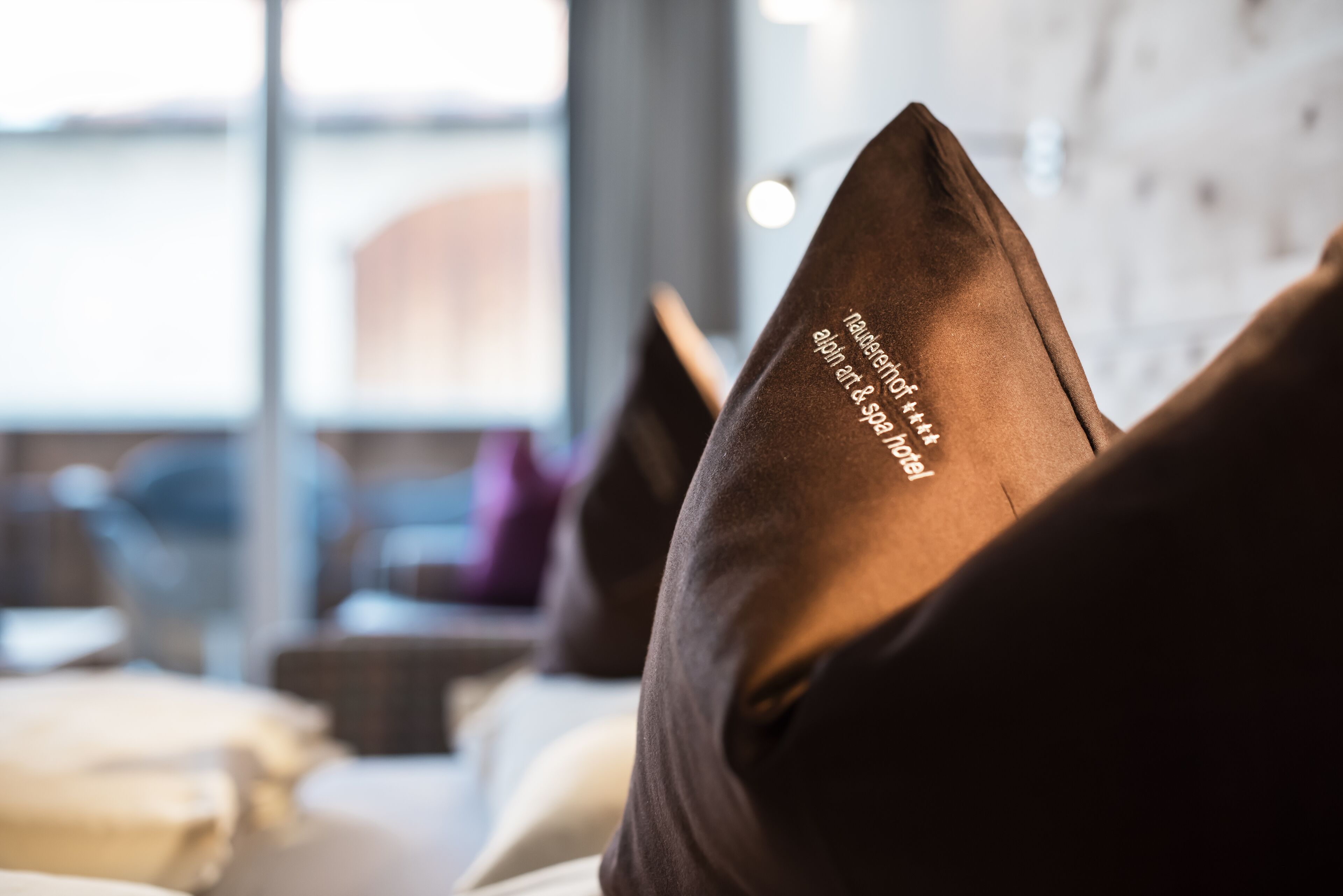 A close-up of a pillow with text indicating it is from a hotel.