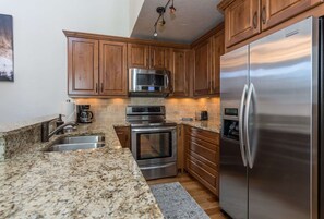 Enjoy cooking in this well-equipped kitchen with an oven, microwave, and refrigerator.